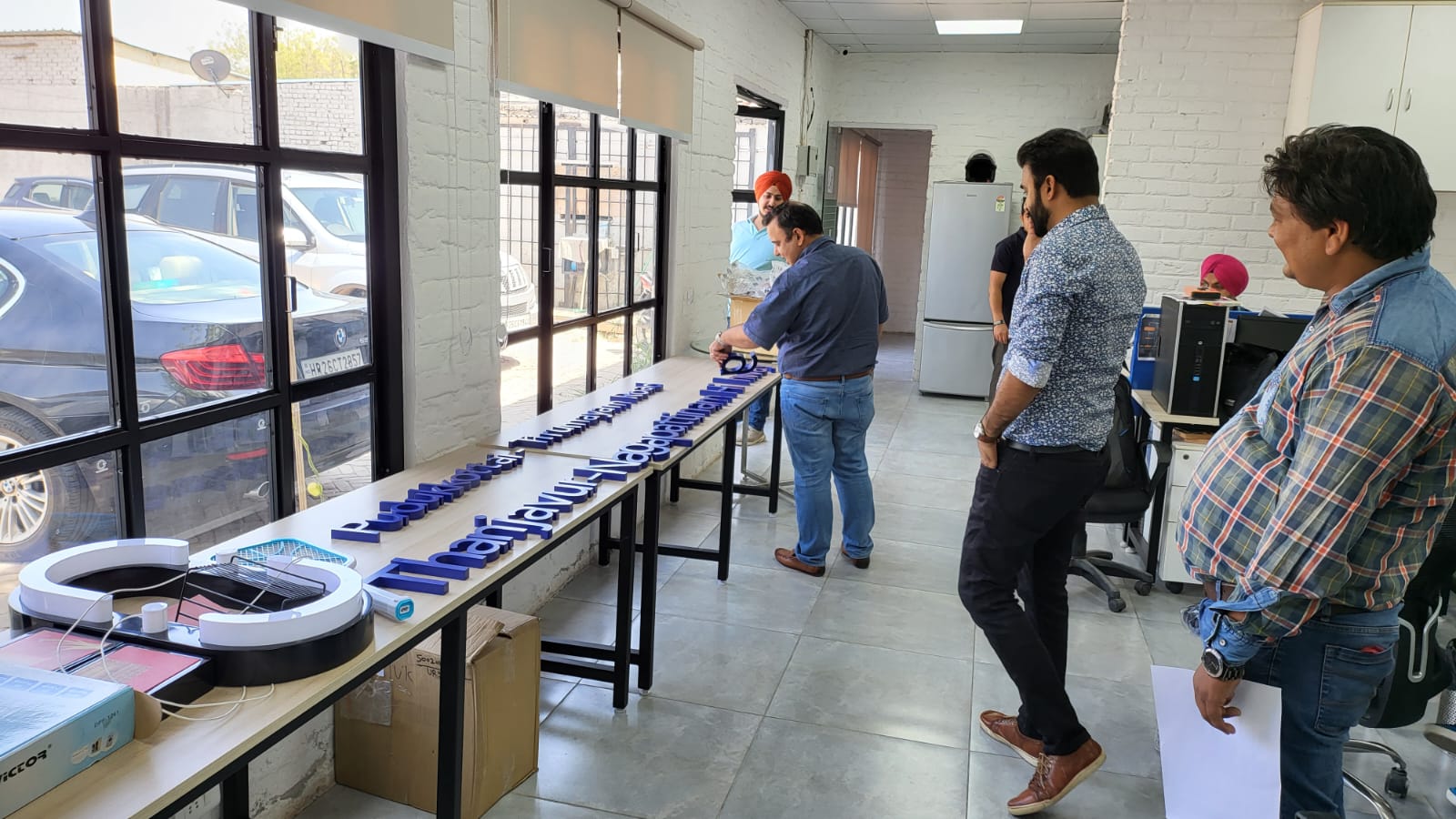 VM Live team assembling dimensional signage letters on a worktable